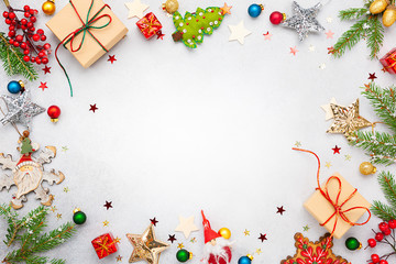 Christmas background with gift boxes, festive decor, fir tree branches and paper cards notes. Flat lay.