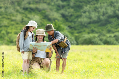 Group asian family children checking map in the jungle adventure and tourism for destination and leisure trips for education and relax in nature park. Travel vacations and Life Concept