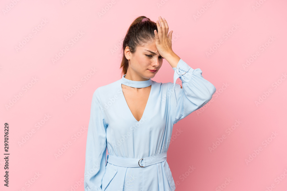 Young brunette girl over isolated pink background having doubts with confuse face expression Young brunette girl over isolated pink background having doubts with confuse face expression