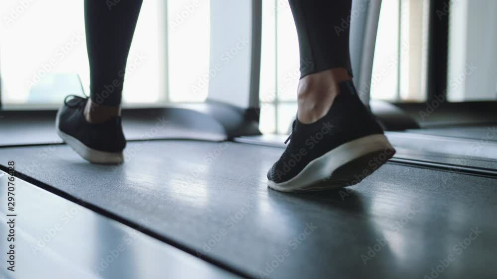 Young Fit Woman Walking on Treadmill in Gym. Cardio Training Weight Loss Concept. 4K Slowmotion Footage. Young Fit Woman Walking on Treadmill in Gym. Cardio Training Weight Loss Concept. 4K Slowmotion Footage.