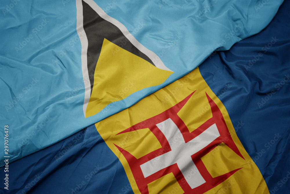 waving colorful flag of madeira and national flag of saint lucia.
