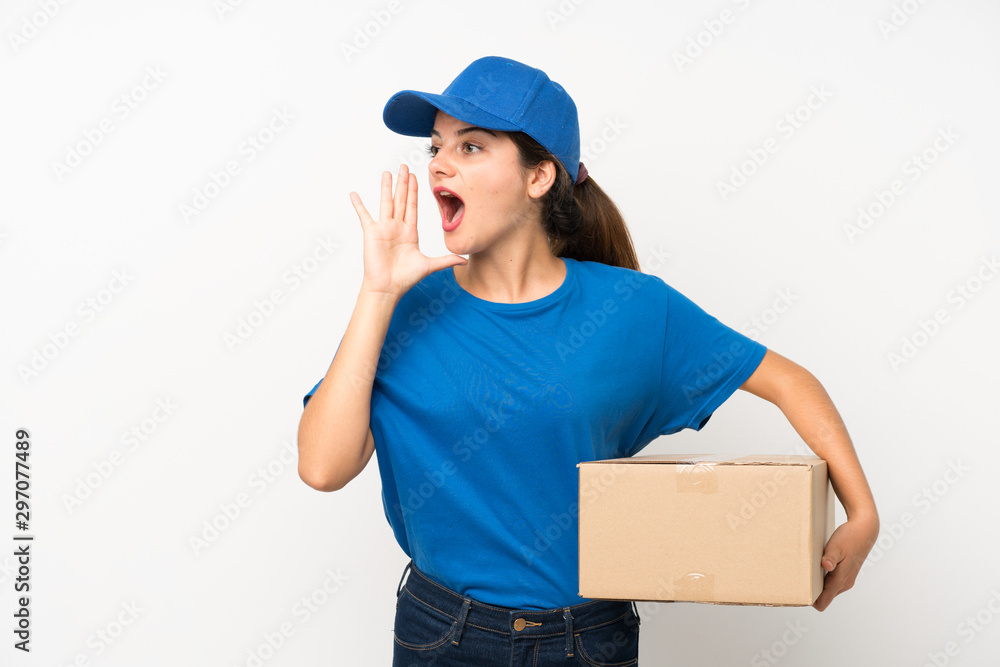 Young delivery girl over isolated white background shouting with mouth wide open Young delivery girl over isolated white background shouting with mouth wide open