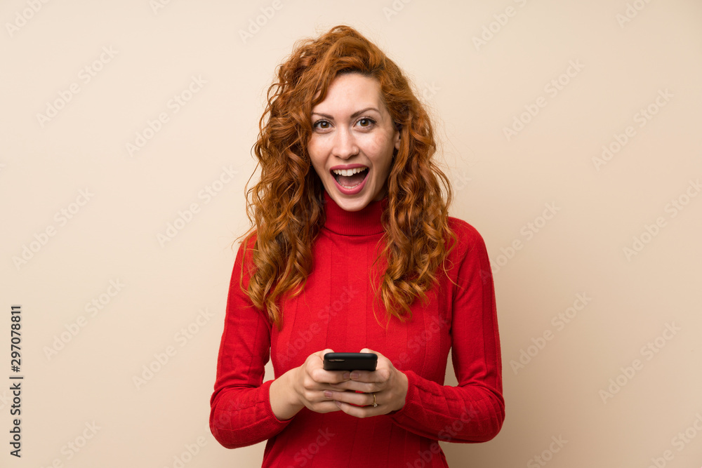 Redhead woman with turtleneck sweater using mobile phone Redhead woman with turtleneck sweater using mobile phone