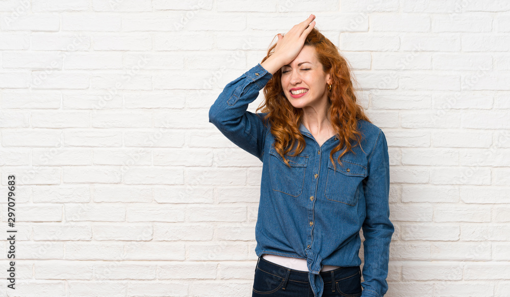 Redhead woman over white brick wall has realized something and intending the solution Redhead woman over white brick wall has realized something and intending the solution
