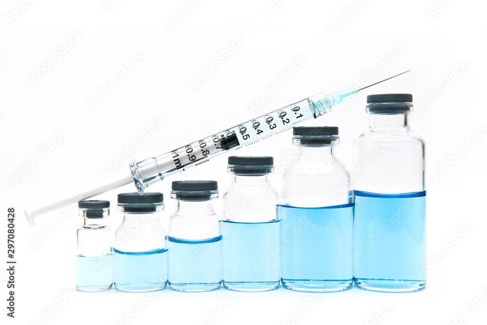 A seringe and serial volume up of medicine vials containing liquid medicine. Growth of pharmaceutical industry A seringe and serial volume up of medicine vials containing liquid medicine. Growth of pharmaceutical industry