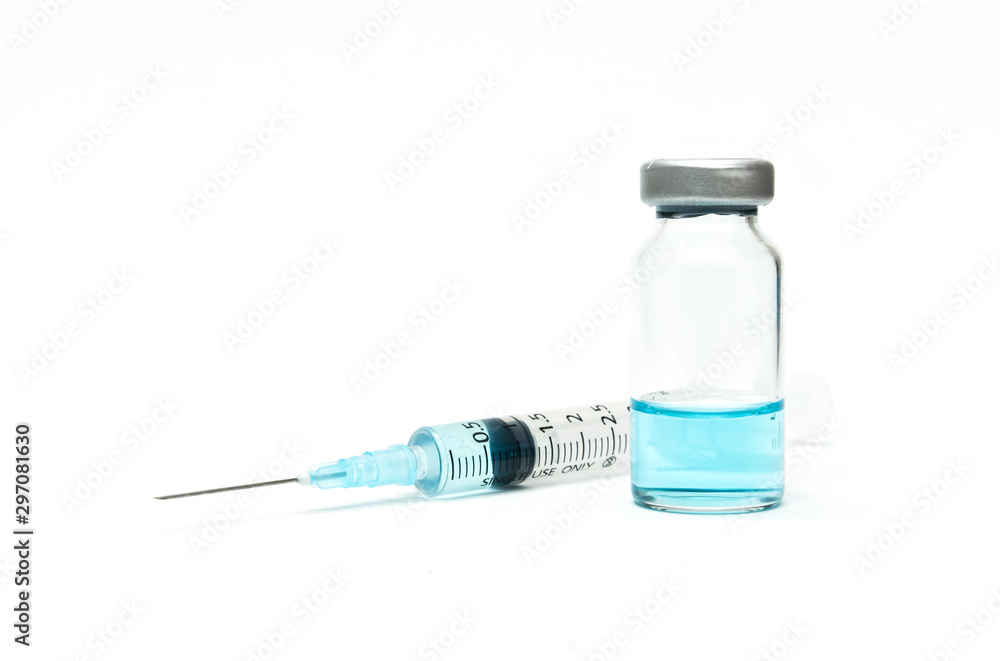 Treatment for rare diseases, virus diseases. A syringe and medicine vials containing blue liquid medicine on the white background Treatment for rare diseases, virus diseases. A syringe and medicine vials containing blue liquid medicine on the white background
