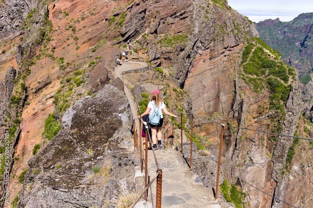 People hiking on a mountain track in Madeira Island (Trekking path in Portugal) People hiking on a mountain track in Madeira Island (Trekking path in Portugal)