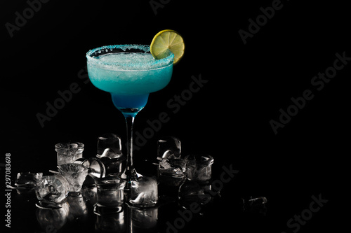 Blue alcoholic cocktail in a black background