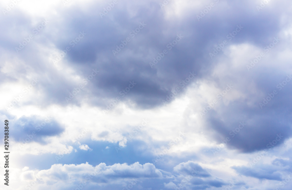 white formidable clouds against a gloomy sky on a cloudy summer day