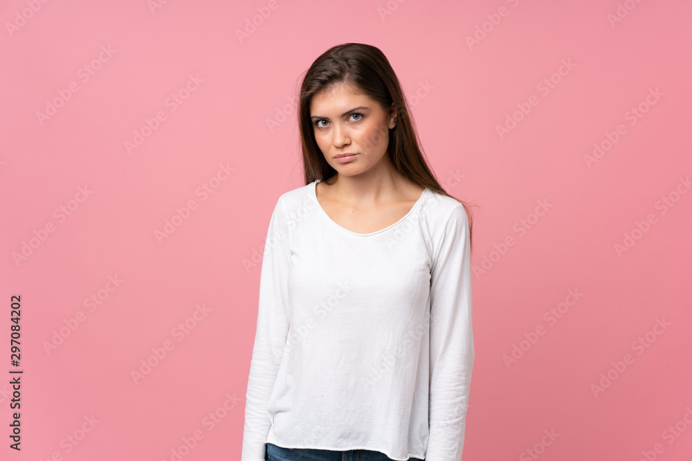 Fototapeta premium Young woman over isolated pink background with sad and depressed expression