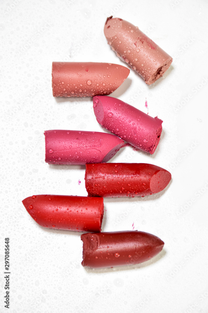 Lipstick broken into pieces, put on a white background.