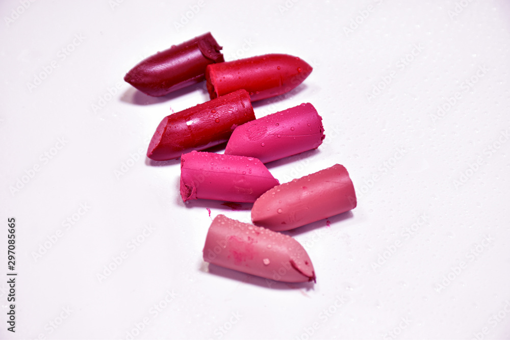 Lipstick broken into pieces, put on a white background. Lipstick broken into pieces, put on a white background.