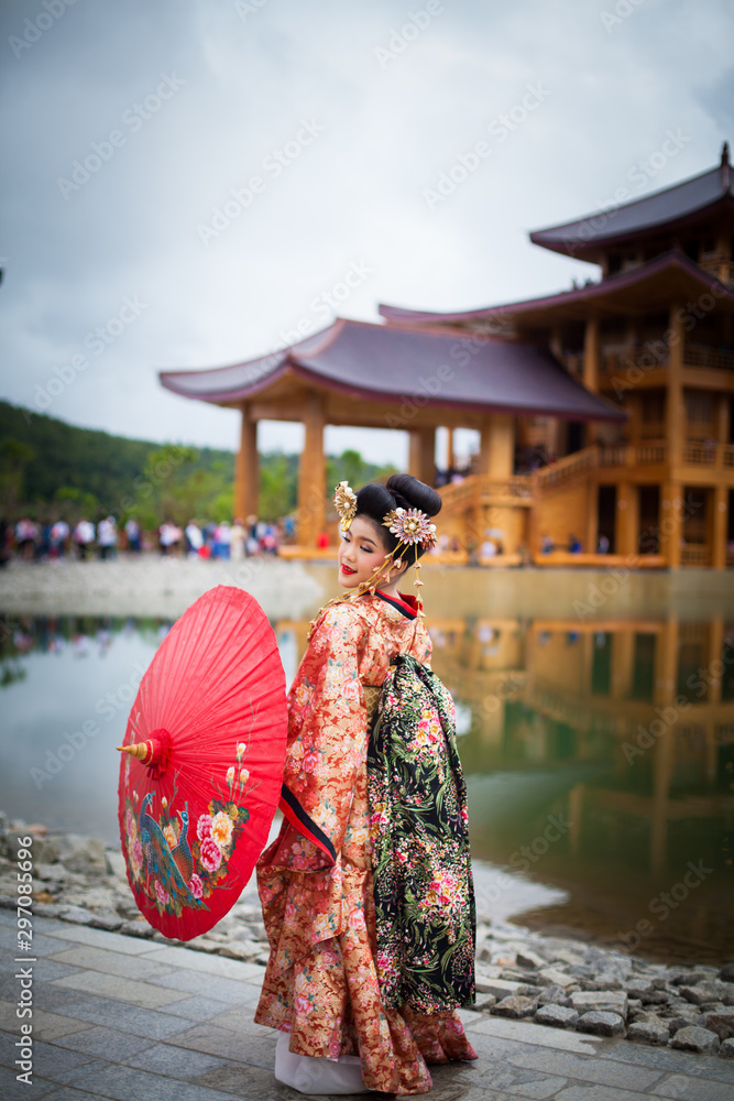 Fototapeta premium Young women wearing traditional Japanese Kimono at Japanese castle