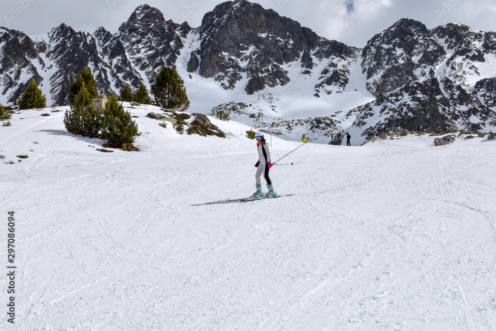 Skier going downhill in slope in popular ski resort Pas de La Casa in Andorra, Pyrenees mountains -Image