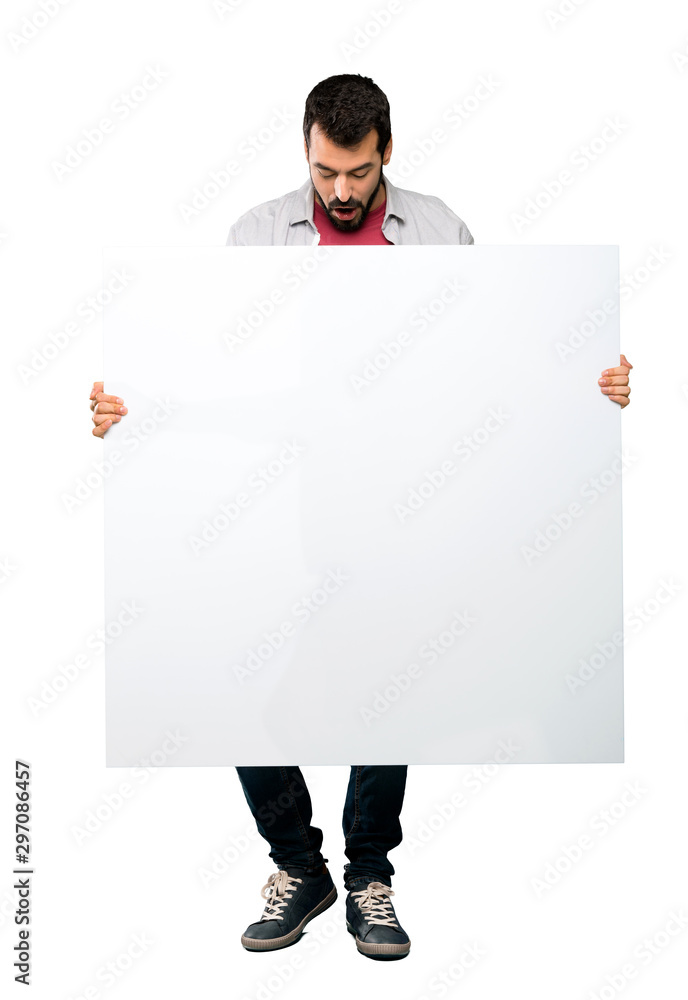 Handsome man with beard holding an empty placard Handsome man with beard holding an empty placard