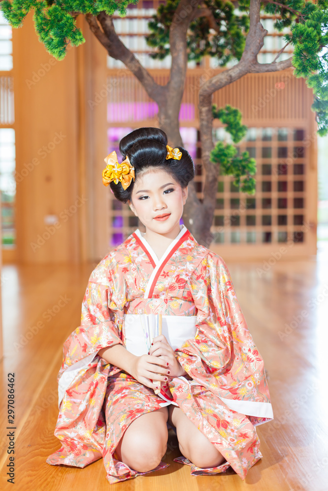 Young women wearing traditional Japanese Kimono at Japanese castle Young women wearing traditional Japanese Kimono at Japanese castle