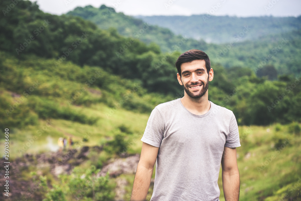 Portrait of young handsome man with beard standing at outdoor,Happy and smiling,Travelling concept Portrait of young handsome man with beard standing at outdoor,Happy and smiling,Travelling concept