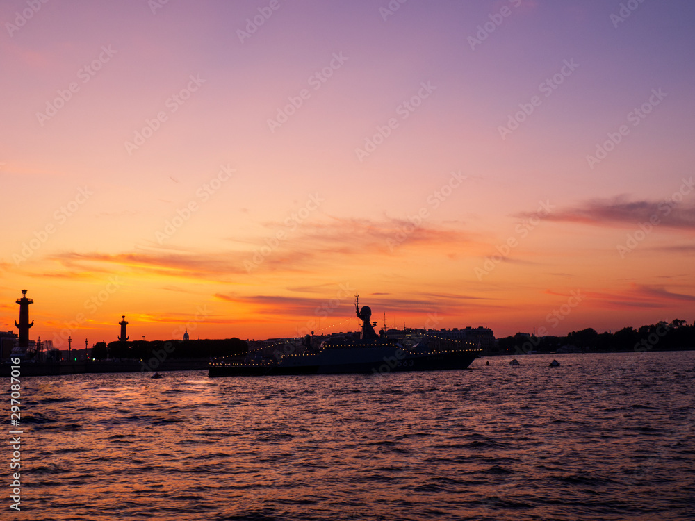 Silhouettes of ships on a sunset background
