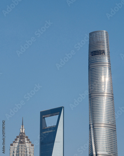 Photography close up image of modern skyscrapers in Shanghai Lujiazui, Shanghai tower, jin mao tower and shanghai world financial center, landmarks with blue sky background