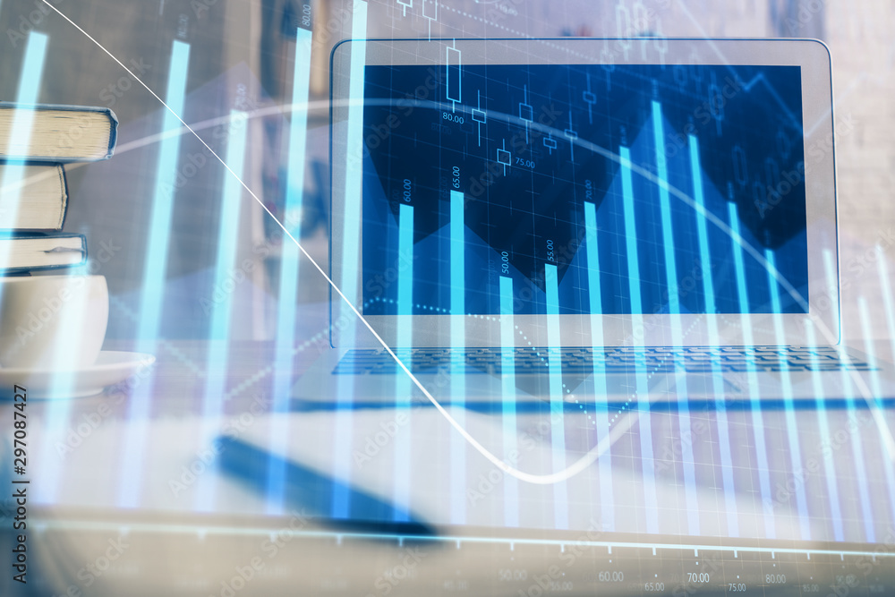 Stock market chart hologram drawn on personal computer background. Multi exposure. Concept of investment. Stock market chart hologram drawn on personal computer background. Multi exposure. Concept of investment.