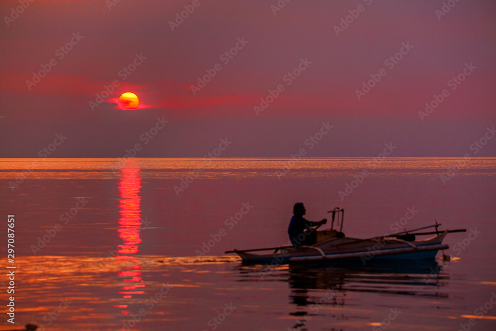 fishermen on boat at sunset