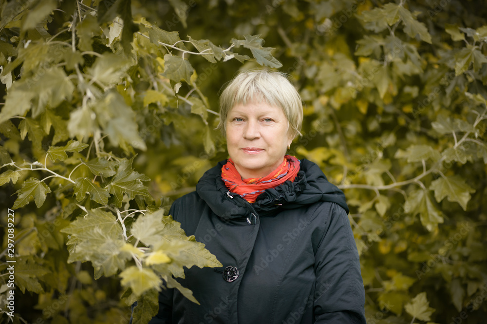 Portrait of a beautiful middle-aged woman outdoors. Selective focus. Portrait of a beautiful middle-aged woman outdoors. Selective focus.