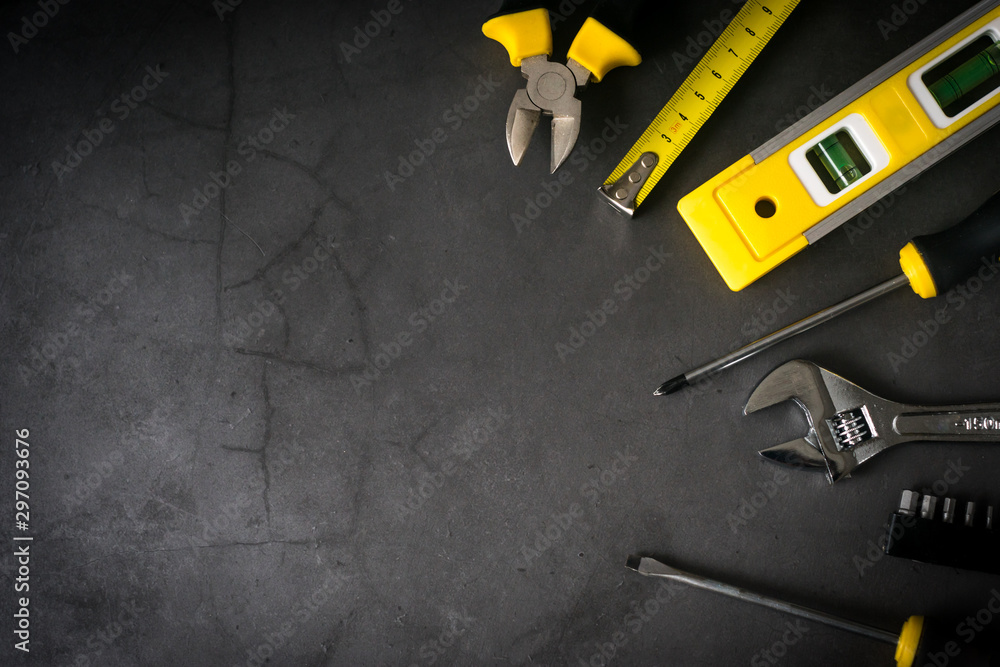 set of tools on one side on concrete black background with empty space