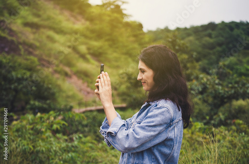 Beautiful woman taking a picture with mobile phone at outdoor,Happy and smiling