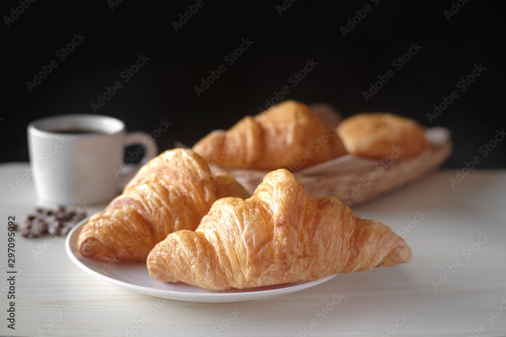 Delicious breakfast with fresh croissants and cup of espresso coffee on wood table. Delicious breakfast with fresh croissants and cup of espresso coffee on wood table.