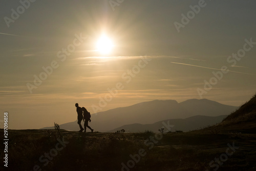 silhouette of man walking on sunset