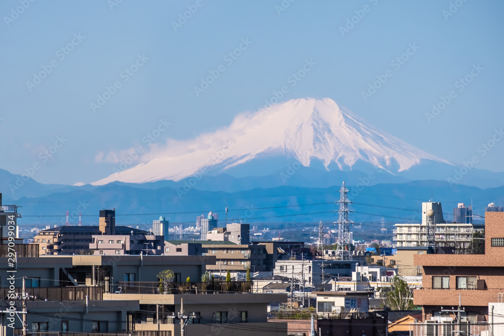 View from train window with Mount Fuji on blue sky background. Fujisan, Japan, Railway Journey.