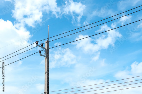 High voltage equipment on an electric pole with blue sky background.