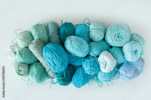 Colored balls and skiens of yarn. Top view. Aquamarine colors. Yarn for knitting.