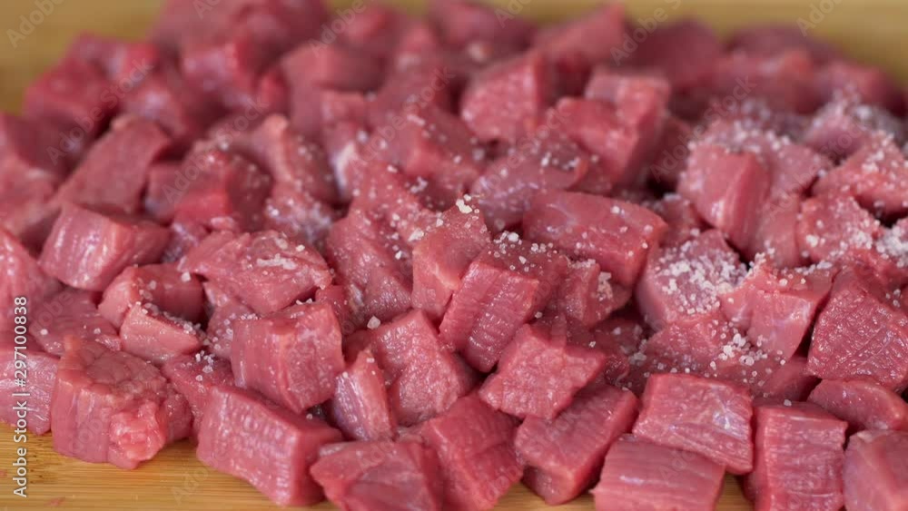 Chef cooking and salting fresh meat , street food. Add a lot of salt falling on meat and stove, close-up Chef cooking and salting fresh meat , street food. Add a lot of salt falling on meat and stove, close-up