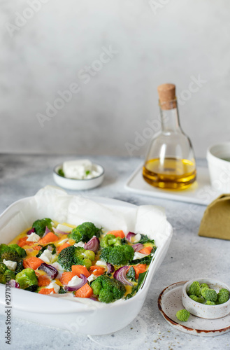 omelette with pumpkin, broccoli and feta on a white dish. light background