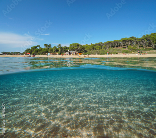 Spain Mediterranean beach in summer and sand underwater sea  split view over and under water surface  Costa Brava  Catalonia  Palamos  Playa El Castell