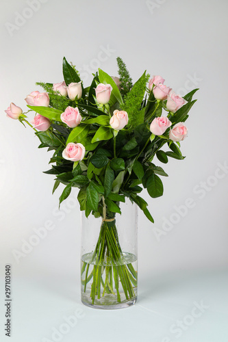 Bouquet of pink roses in vase isolated on white.