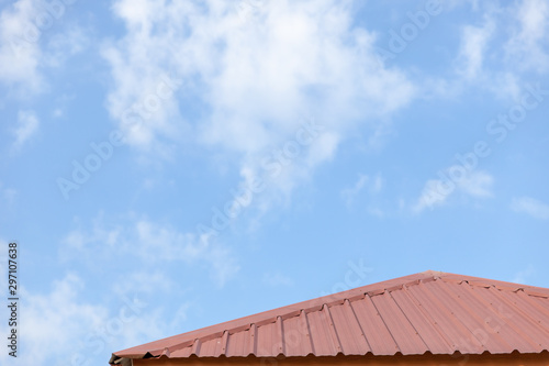 Close up of galvanized roof. Red old dirty roof. Construction equipment build a house.