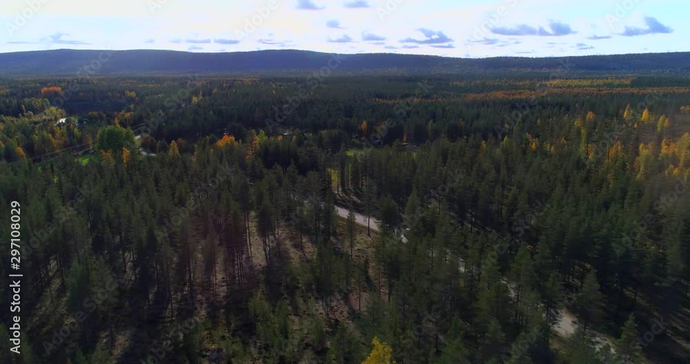 Motorhome on a forest road, Aerial, drone shot, of a camper van, driving on a asphalt route, in middle of fall colored trees, on a partly sunny, autumn day, in Pyha-Luosto national park, Finland Motorhome on a forest road, Aerial, drone shot, of a camper van, driving on a asphalt route, in middle of fall colored trees, on a partly sunny, autumn day, in Pyha-Luosto national park, Finland