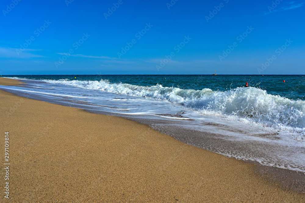 sandy beach and waves in Mediterranean sea