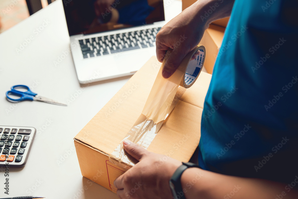 Man worker delivery service and working packing box, business owner working checking order to confirm before sending customer in post , Shipment Online Sales