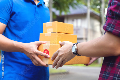 Man hand accepting a delivery of boxes from deliveryman.Courier service concept