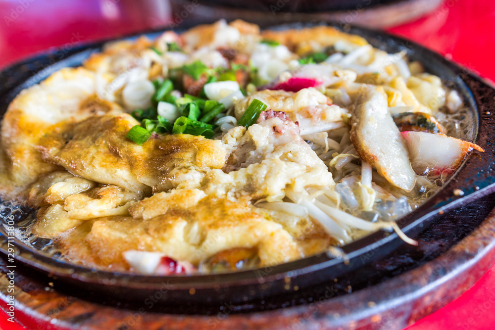 Closed-up of Fried mussel pancakes, Cooking mussel fried in egg batter on iron pan. Street food of Thailand. Closed-up of Fried mussel pancakes, Cooking mussel fried in egg batter on iron pan. Street food of Thailand.