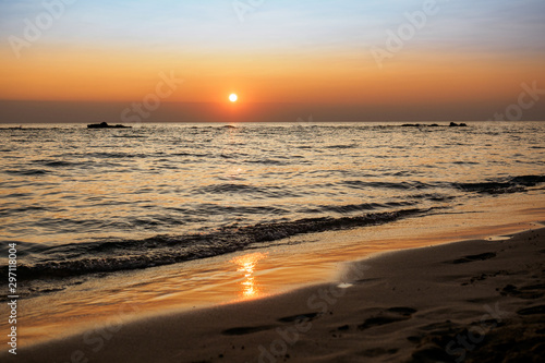 Scenic view of a summer sunset on the Ionian sea near Gallipoli, a town in the Apulian region (Italy). Landscape format.