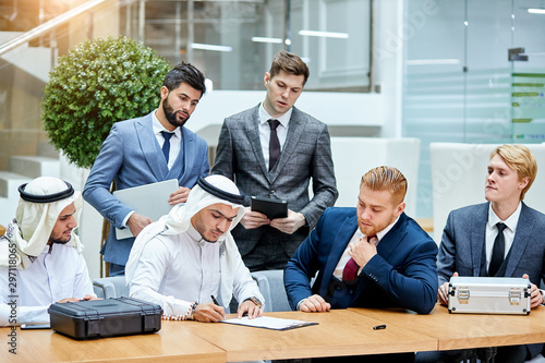 Photography Business meeting of sheikh and caucasian men, signing new contract