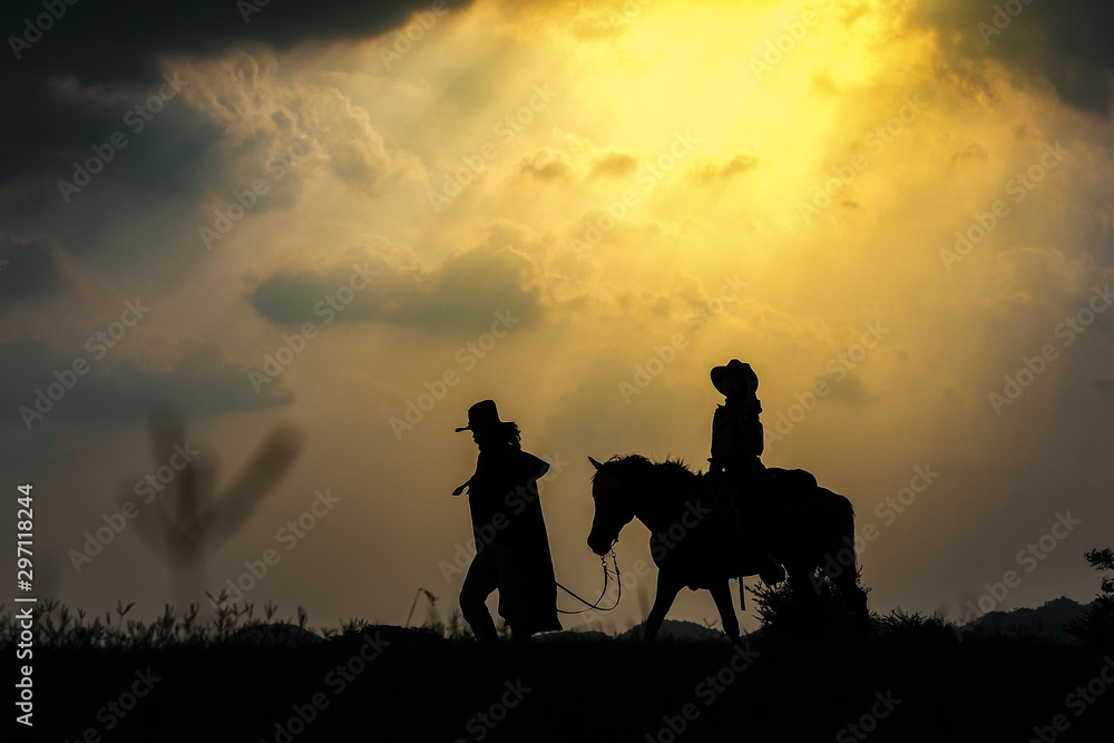 Cowboy silhouette on a horse during nice sunset
