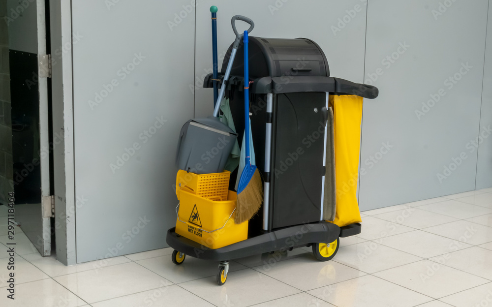 closeup of janitorial. yellow mop bucket and set of cleaning equipment at the airport. closeup of janitorial. yellow mop bucket and set of cleaning equipment at the airport.