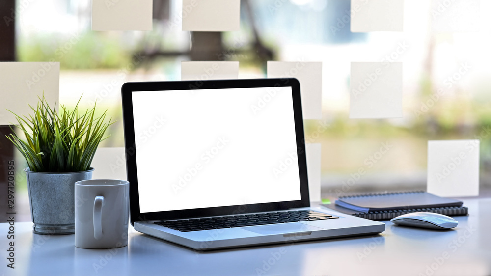 Laptop computer with empty screen on workspace office table. Laptop computer with empty screen on workspace office table.
