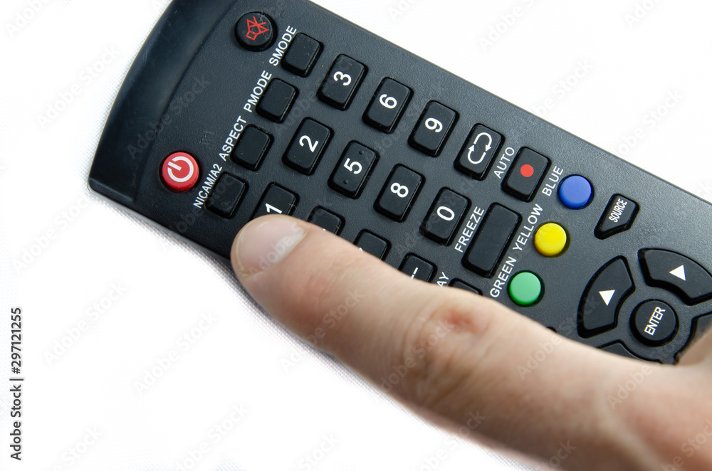 TV remote control in male hands on a white background. Remote control for household appliances, for smart gadgets using the IR port TV remote control in male hands on a white background. Remote control for household appliances, for smart gadgets using the IR port