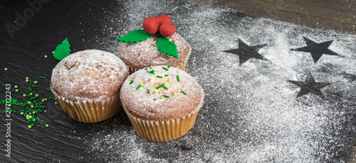 Cooking Christmas Cupcakes. Christmas cupcakes decorated with mistletoe. Christmas sweet food. Mini muffins.